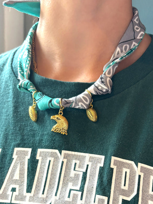 Person wearing a green 'Philadelphia' t-shirt with a necklace